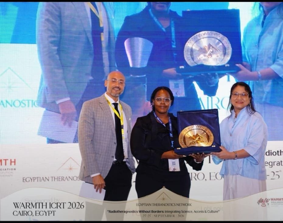 Yonwaba Mzizi receiving the Best Abstract Award on stage at WARMTH ICRT 2026 in Cairo, Egypt